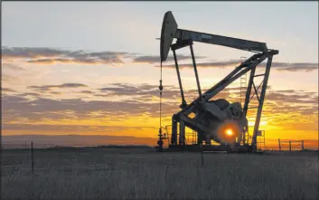  ?? The Associated Press file ?? A Whiting Petroleum Co. pumpjack pulls crude oil near Bainville, Mont., in 2013.