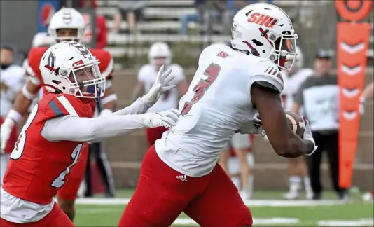  ?? Matt Freed/Post-Gazette ?? Sacred Heart’s Naseim Brantley runs for the winning touchdown ahead of Duquesne’s Spencer DeMedal in overtime Sunday at Rooney Field.