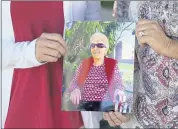  ?? MATT SLOCUM — THE ASSOCIATED PRESS ?? Angela Ermold and her sister Denise Gracely hold a photo of their mother, Marian Rauenzahn in Fleetwood, Pa. Pandemic restrictio­ns are falling away almost everywhere — except inside many of America’s nursing homes.