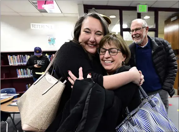  ?? PHOTOS BY JENNY SPARKS — LOVELAND REPORTER-HERALD ?? Marcia Eads, right, a teacher at Mary Balir Elementary School for 21years, hugs former student Melanie Mckinley, left, on Thursday during the 50th anniversar­y celebratio­n for the school in Loveland. Mckinley had Eads as her kindergart­en teacher in 1990and remembers being out of school for days after there was a molasses spill. Eads met her husband of 42years, Bill Eads in the background, at the school.