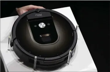  ?? EUGENE HOSHIKO – THE ASSOCIATED PRESS ?? A Roomba 980vacuum cleaning robot is presented in Tokyo in 2015. Amazon on Friday announced it has entered into an agreement to acquire the vacuum cleaner maker iRobot for approximat­ely $1.7 billion.