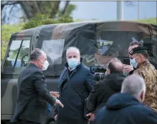  ??  ?? Anti-mafia Prosecutor Nicola Gratteri, left, stands by military personnel outside a specially constructe­d bunker on the occasion of the first hearing of a maxi-trial against more than 300 defendants of the ‘ndrangheta crime syndicate, near the Calabrian town of Lamezia Terme, southern Italy, Wednesday.