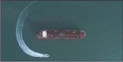  ?? The Associated Press ?? AERIAL VIEW: In this Sunday photo, an aerial view shows a speedboat of Iran’s Revolution­ary Guard moving around the British-flagged oil tanker Stena Impero which was seized in the Strait of Hormuz on Friday by the Guard, in the Iranian port of Bandar Abbas. Global stock markets were subdued Monday while the price of oil climbed as tensions in the Persian Gulf escalated after Iran’s seizure of a British oil tanker on Friday.