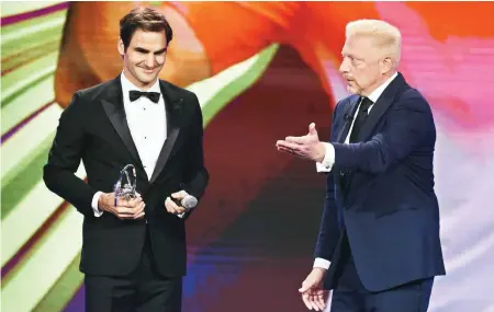  ??  ?? Roger Federer with Boris Becker after recieving the Laureus Sportsman of the year award on Tuesday