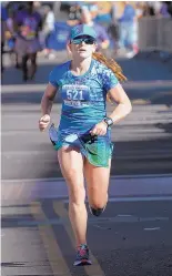  ??  ?? Roxanne Wegman, running her first traditiona­l marathon, is a veteran of ultra-marathons. She decided to run the Duke City while training for the Army 10-miler.