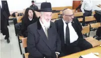  ?? (Yonah Jeremy Bob) ?? FORMER CHIEF RABBI Yona Metzger (left) waits in the Jerusalem District Court yesterday.