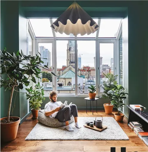  ?? PHOTOS BY ARASH MOALLEMI ?? Once carpeted and underused, this former sitting room is now the condo’s focal point. The new sunroom’s green walls pull colour from nearby St. James Cathedral to bring the oudoors in. Furnishing­s from EQ3; pendant from Lightform.