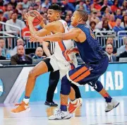  ?? [AP PHOTO] ?? In this March 2017 photo, Virginia’s Devon Hall, right, defends Florida’s Devin Robinson during the NCAA Tournament. Hall is a prospect who might earn a spot on the Thunder roster this fall.