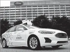  ?? JEFF KOWALSKY/GETTY-AFP ?? Ford and Volkswagen will become equal owners of Argo AI, sharing the costs and risks of developing driverless cars.