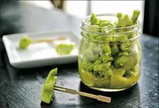  ??  ?? These pickled broccoli stems are a perfect nibbler for cocktail parties, and completely addictive.
broccoli stems and cut them into inch-thick slices. Toss the stems with salt in a jar and refrigerat­e overnight. In the morning, pour off the water that...