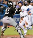  ?? THE CANADIAN PRESS/FRANK GUNN ?? Toronto Blue Jays left-fielder Steve Pearce (28) is thrown out on his way to home plate by Chicago White Sox catcher Alfredo Gonzalez (70) during fifth inning American League baseball action in Toronto, Friday.