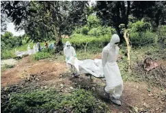  ?? Picture: Mohammed Elshamy/Anadolu Agency/Getty Images ?? Volunteers wear special protective gear for the burial of people, sterilised after dying of Ebola, in Kptema graveyard in Kenema, Sierra Leone, on August 24 2014.