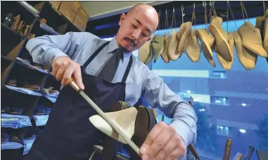  ?? KAZUHIRO NOGI / AGENCE FRANCE-PRESSE ?? Japanese master shoemaker Yohei Fukuda creates shoes in his workshop in Tokyo. Each pair takes between 120 and 140 hours.