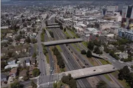  ?? PHOTO: JANE TYSKA — BAY AREA NEWS GROUP ?? Interstate 980and the 12th Street, 14th Street, 17th Street and 18th Street overpasses, from right, are seen from this drone view in Oakland, May 4, 2021. The constructi­on of Interstate 980 tore through historical­ly Black neighborho­ods.