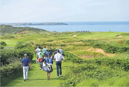  ?? THOMAS J. RUSSO/USA TODAY SPORTS ?? Players walk from the fitth tee box during a practice round Tuesday for the British Open Championsh­ip tournament at Royal Portrush Golf Club - Dunluce Course.