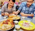  ?? (AFP) ?? Biryani recipe has endless variations: People eat biryani at a restaurant in Karachi.