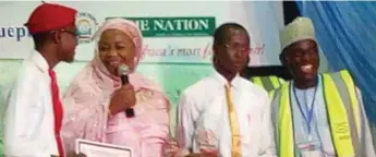  ??  ?? L-R: Student of Alhudahuda College, Nurudeen Muhammad; President of KADCCIMA, Dr Muheeba Farida Dankaka; Student of Alhudahuda College, Aliyu Muhammad; and Quiz Master, Mr. Ezekiel David, during the presentati­on of plaque to the champions at the 7th...