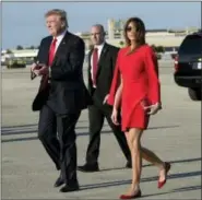  ?? SUSAN WALSH — THE ASSOCIATED PRESS ?? President Donald Trump walks with first lady Melania Trump after she greeted him on the tarmac after he arrived via Air Force One at Palm Beach Internatio­nal Airport in West Palm Beach, Fla. last February.
