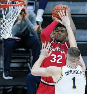  ?? MICHAEL CONROY — THE ASSOCIATED PRESS ?? Ohio State forward E.J. Liddell (32) shoots over Michigan center Hunter Dickinson (1) in the first half of Saturday’s game at the Big Ten Conference tournament in Indianapol­is.