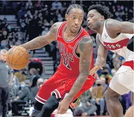  ?? NATHAN DENETTE/AP ?? Bulls forward DeMar DeRozan moves the ball around Raptors forward OG Anunoby on Monday in Toronto.