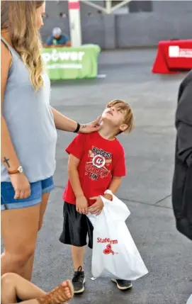  ?? STAFF PHOTO BY DOUG STRICKLAND ?? Landon Shaffner lets his mother, Brianna Shaffner, check out his face paint during Hamilton County Schools’ Parent University kickoff event at the First Tennessee Pavilion on Saturday.