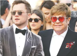  ?? THE ASSOCIATED PRESS ?? Actor Taron Egerton, left, said he prepared for his role in Rocketman by hanging out with music legend Elton John. “You really can ask him anything,” Egerton said. “He’ll tell you everything.”