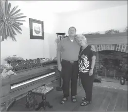  ?? STAFF PHOTO BY DARWIN WEIGEL ?? Peter J. “Pete” and Mary Swann pose for a picture next to the square grand piano in on of the front parlors of Maxwell Hall in Hughesvill­e. Pete was one of the last people to live in the house when he helped his parents, Edwin O. and Marion M. Swann, restore it in the early 1980s.