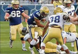  ?? HYOSUB SHIN / HSHIN@AJC.COM ?? Clinton Lynch (22) is taken down by Tariq Carpenter (29) during the 2018 Georgia Tech spring game on Friday at Bobby Dodd Stadium.