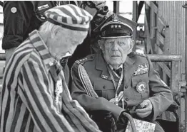  ?? SEAN GALLUP/GETTY ?? A Polish military veteran and a concentrat­ion camp survivor attend an internatio­nal ceremony to commemorat­e the 80th anniversar­y of the outbreak of World War II on Sunday in Warsaw. Germany’s invasion of Poland started a war that ravaged Europe.