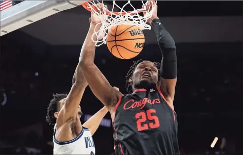  ?? David J. Phillip / Associated Press ?? Houston center Josh Carlton dunks in front of Villanova forward Jermaine Samuels on Saturday in San Antonio.