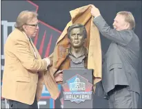  ?? DAVID RICHARD — THE ASSOCIATED PRESS ?? Tom Flores, left, a Pro Football Hall of Fame Class of 2021 inductee, and his presenter, Las Vegas Raiders owner Mark Davis, unveil the bust honoring the two-time Super Bowl-winning head coach.