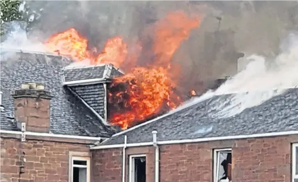  ?? ?? Flames erupt from the roof of the former St Joseph’s Wellburn Care Home on Liff Road, tackled by four fire appliances and their crews.