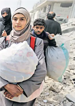  ??  ?? Civilians escape Syria’s rebel-held Eastern Ghouta through the regime-controlled corridor into government-held territory