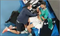  ?? (AFP) ?? Serbian Novak Djokovic gets medical treatment while playing against Taylor Fritz of the US at the Australian Open in Melbourne on Friday.