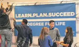  ?? | FRAN SPIELMAN/ SUN- TIMES ?? A banner is set up before last month’s official announceme­nt at Malcolm X College of a new graduation requiremen­t for CPS students.