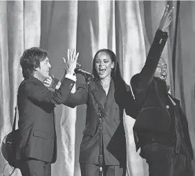  ?? JOHN SHEARER/ INVISION/ AP ?? Paul McCartney, left, Rihanna and Kanye West perform at the 2015 Grammy Awards in Los Angeles.