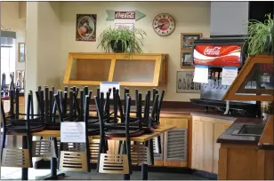  ??  ?? The lobby and signature condiment bars at Burger Hut on Forest Avenue in Chico are closed due to COVID-19restrict­ions. Both of Burger Hut’s Chico locations are open for takeout, outdoor dining and delivery and the condiments now come in a plastic container on the side of the burger.