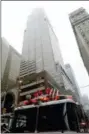  ?? MARK LENNIHAN — THE ASSOCIATED PRESS ?? New York firefighte­rs respond to the scene where a helicopter was reported to have crash landed on top of a building in midtown Manhattan, Monday in New York.