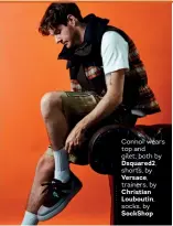  ??  ?? Connor wears top and gilet, both by
Dsquared2,
shorts, by
Versace,
trainers, by
Christian Louboutin,
socks, by SockShop