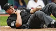  ?? RON SCHWANE / AP ?? Home plate umpire Quinn Wolcott falls to the ground after getting hit by a Tigers pitch in Detroit’s loss Wednesday to the Cleveland Indians.