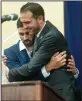  ??  ?? Basim Elkarra, director of the Sacramento chapter of the Council on American-Islamic Relations, right, hugs Hamid Hayat during a press conference in Sacramento.