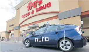  ??  ?? A self-driving Toyota Prius parks outside a Fry’s supermarke­t, which is owned by Kroger Co, as part of a pilot programme with Silicon Valley startup Nuro for grocery deliveries in Scottsdale, Arizona on Thursday.