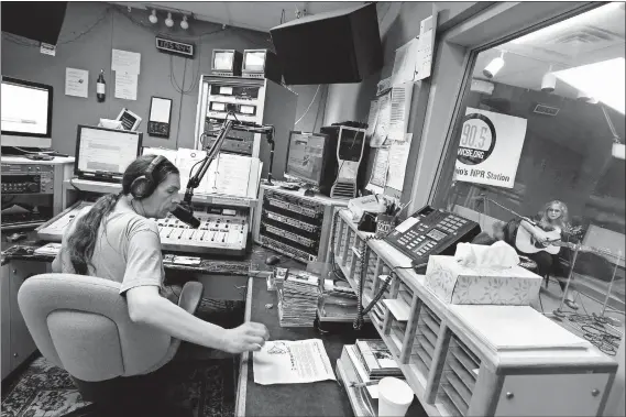  ?? [FRED SQUILLANTE/DISPATCH] ?? Mike Taylor of Columbus public radio station WCBE (90.5 FM) is on air as touring musician Gretchen Peters, in the studio at right, waits with her guitar to perform three songs on a live broadcast Thursday.