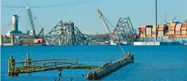  ?? AMY DAVIS/STAFF ?? The wreckage of the Francis Scott Key Bridge rests in the Patapsco River, embedded with the container ship Dali, which struck the bridge March 26, causing the collapse which killed six workers.