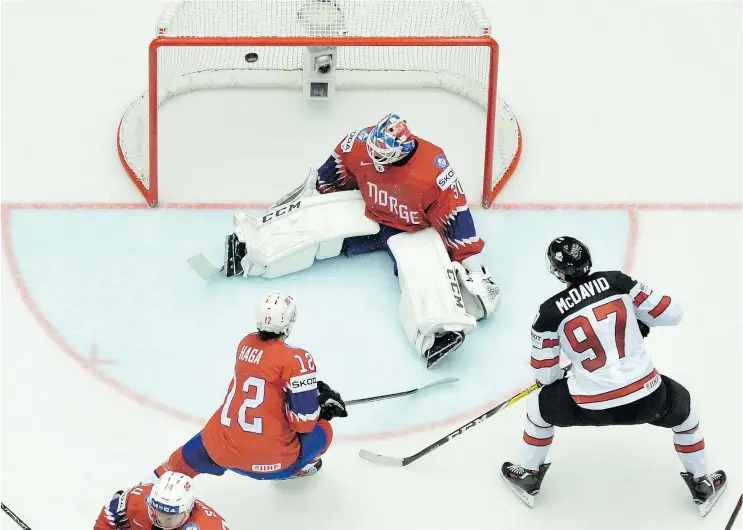  ?? — GETTY IMAGES ?? Connor McDavid fires the puck past Norway goalie Lars Haugen during Canada’s 5-0 win on Thursday at the World Hockey Championsh­ip in Herning, Denmark.