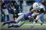  ??  ?? West Virginia wide receiver Jordan Thompson, right, is tackled by Kansas State defensive back Kendall Adams.