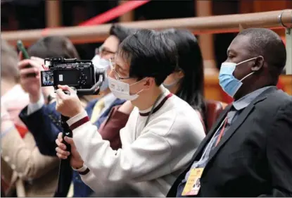  ?? WANG ZHUANGFEI / CHINA DAILY ?? The opening meeting of the first session of the 14th National People’s Congress drew huge interest from foreign media and the diplomatic community.