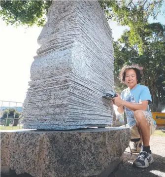  ?? Picture: RICHARD GOSLING ?? Hwang Seung Woo with his sculpture carved from three tonnes of solid granite, which has now found a home in Brisbane.