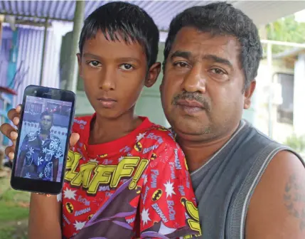  ?? Photo: Simione Haravanua ?? Arvind Sharma (right), with nephew Shavneel holding a picture of his late father, Umeshwar Prakash, at their Sawani home on August 11, 2019.