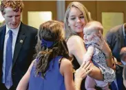  ?? Elise Amendola / Associated Press file ?? Shown in 2016, Saoirse Kennedy Hill holds a relative’s baby. “The world is a little less beautiful today,” said her grandmothe­r, Ethel Kennedy.